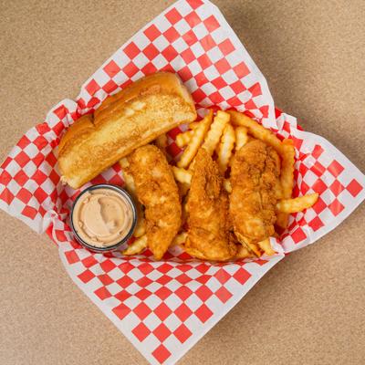 A basket of fried chicken tenders, crinkle-cut fries, toasted bread and dipping sauce..