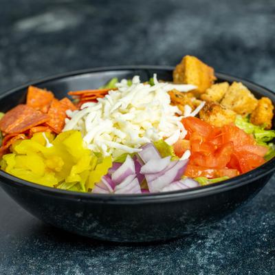 Bowl of North Salad with croutons, grated cheese and pepperoni slices.