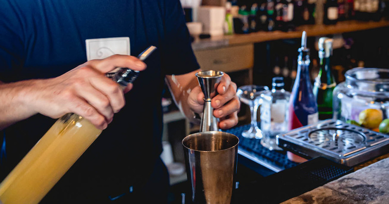 A staff member making cocktails