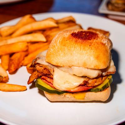 Cuban sandwich, served with fries, front view, closeup.