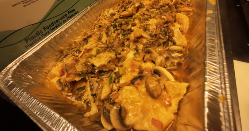 Chicken Marsala with mushrooms and wine sauce in a catering tray
