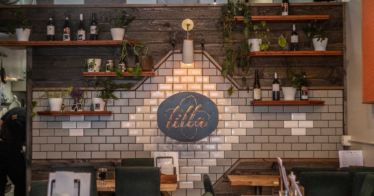 Diner area, tables, chairs, sign on the wall