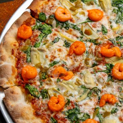 Pizza with shrimp, spinach, artichoke and green chilies.