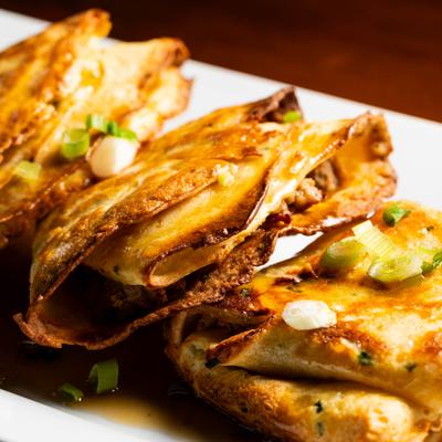 Duck sausage and kimchi crepes, closeup.
