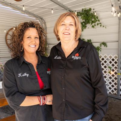 Two staff members posing on the patio.