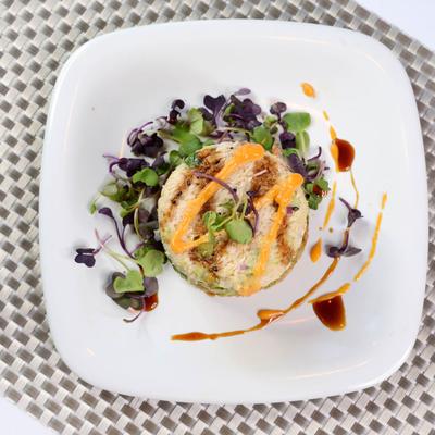 Snow crab meat and crispy brown rice salad tower, top view.