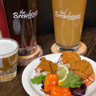 Stuffed shrimp, smothered in sauce, with lettuce and peppers.