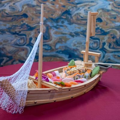 Love Boat with sashimi, sushi, California Roll, Monster Roll and garnsihes.