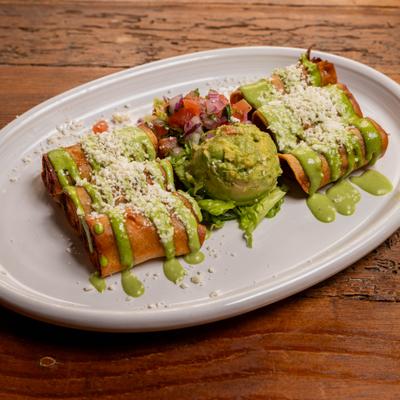 Taquitos with cilantro crema, queso fresco, guacamole and pico de gallo.