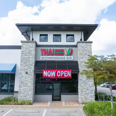 Front of Thai Spice Garden restaurant with a NOW OPEN sign.