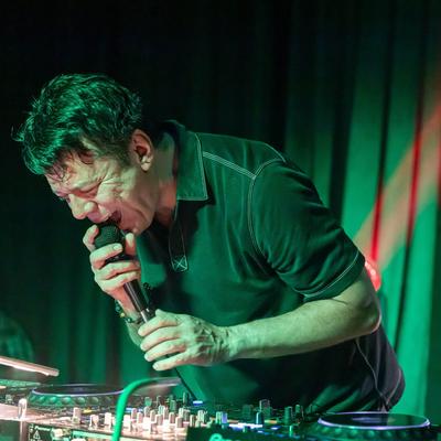 DJ singing and mixing music.