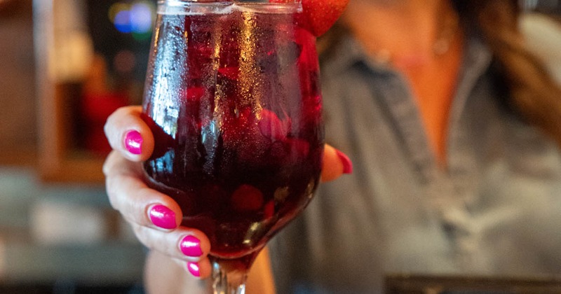 Person holding a red drink