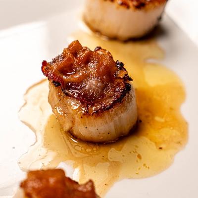 Scallops topped with bacon, close up.