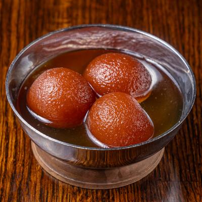 Pastry balls made with milk and soaked in light, warm sweet syrup.