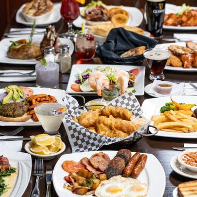 Assortment of dishes served on the table with drinks.