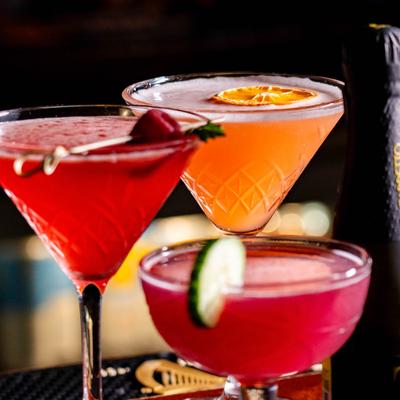 Close-up of assorted cocktails with fruit garnishes.
