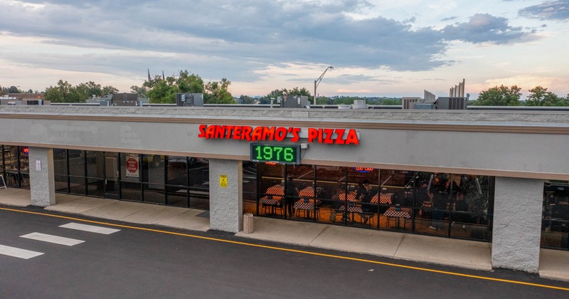 Santeramo’s Pizza storefront with bright red signage and a green 1976 display