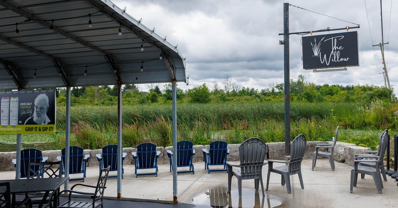 Outdoor seating area at "The Willow" with chairs, tables