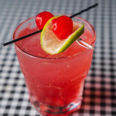 Raspberry Mule garnished with raspberries, lime and lemon slices on a skewer.