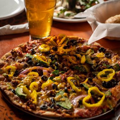 Mexican Specialty Pizza with a glass of beer
