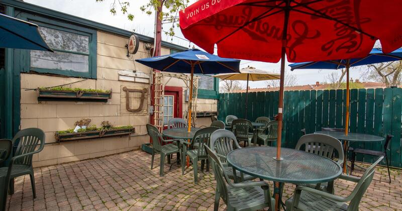 Patio, tables and seating with parasols