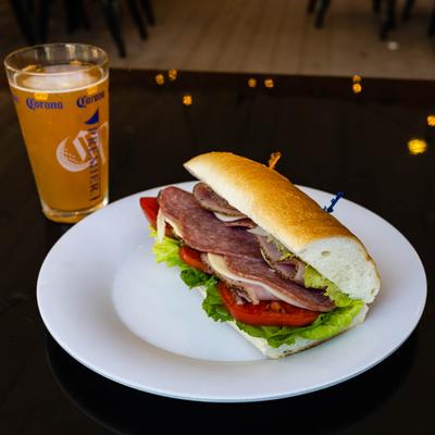 Italian Cold Cut Sub, served with a glass of beer