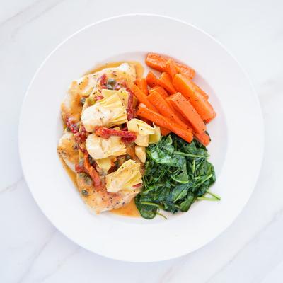 Chicken in lemon caper sauce, with artichoke hearts, spinach, and carrots.