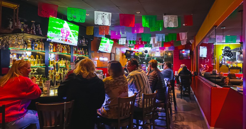 Bar, guests, decoration flags above