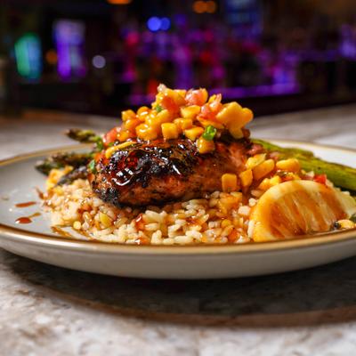 Citrus salmon served with rice and asparagus.