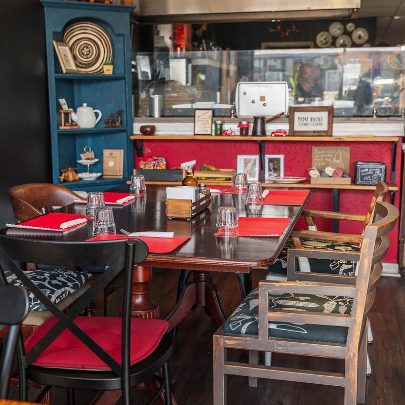 Interior, table ready for guests with counter in the back