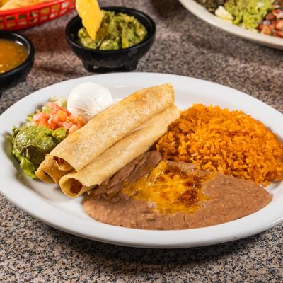 Chicken Taquitos served with refried beans, rice, sour creme and guacamole.