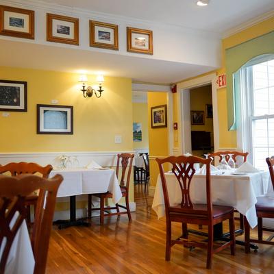 Interior, tables, chairs, frames on walls.