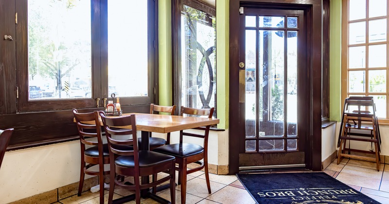 Dining table for four guests by the entrance door