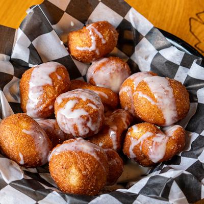 Fritter balls with white glaze.