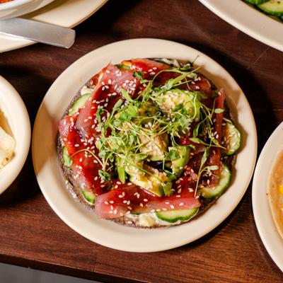 Tuna served on a crispy corn tostada shell layered with avocado and cucamber.