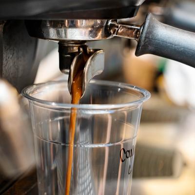 Espresso pouring into a clear cup.
