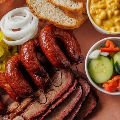 Brisket, sausages, veggie salad, mac and cheese, and bread.