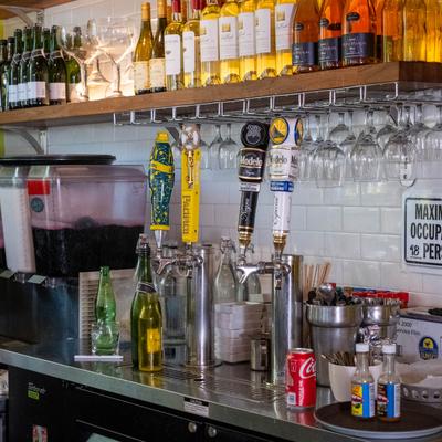 Beer taps, wine bottles, and juice dispensers.