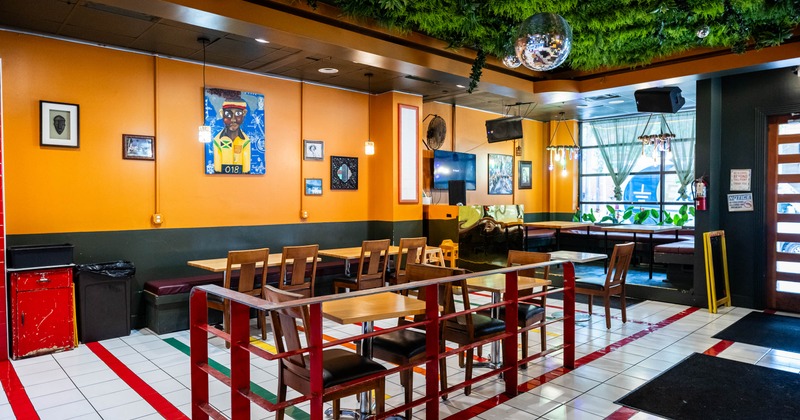 Interior, dining area, orange walls, disco balls, wooden tables, patterned tile floors