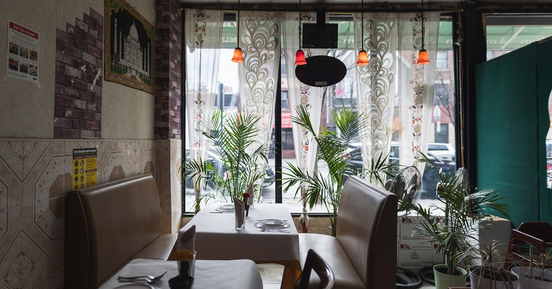 Interior, dining booth with set table by the window