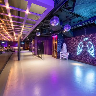 Interior - shining mirror disco balls, illuminated neon angel wings and halo on the wall