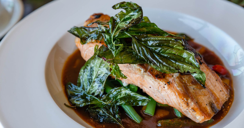 Pan seared salmon in a sauce with green beans and basil