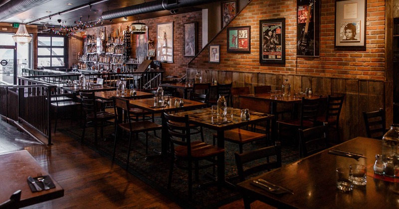 Interior, set tables, frames on walls, glass door, windows