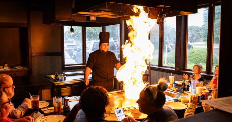 Chef performing a cooking trick for the customers