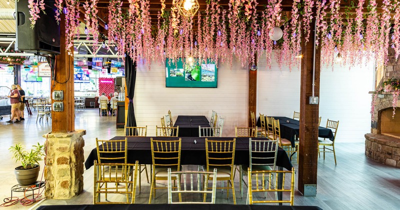 Interior seating area with chairs and tables, floral decoration