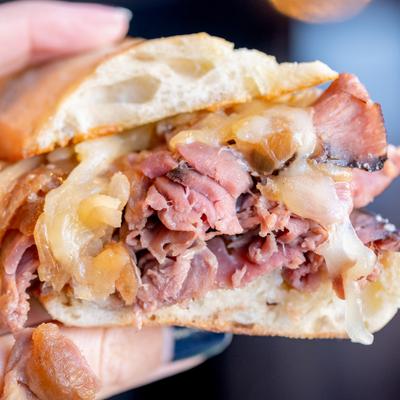 Thin sliced rare roast beef French roll.