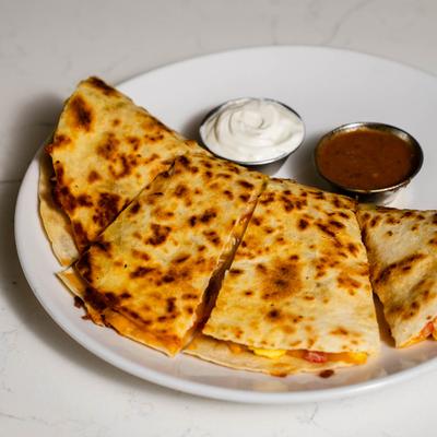 Quesadillas, with sour cream and salsa.