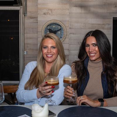 Two patrons enjoying Espresso Martini at a table.