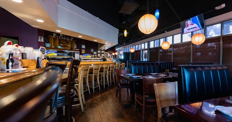 Interior, bar stools lined up, bar in the back