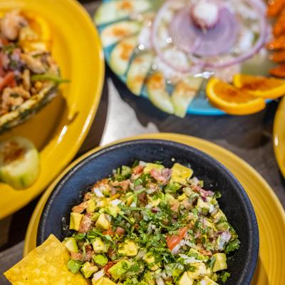 Mexican Guacamole served with tortilla chips and other Mexican dishes.
